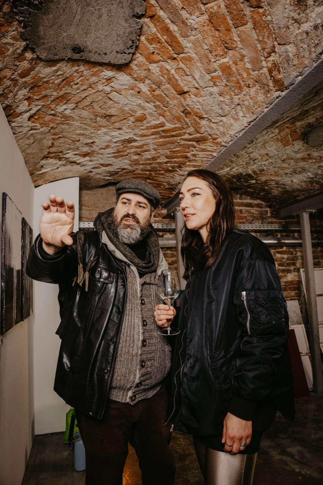 Reference image of two visitors discussing artworks at a gallery gathering